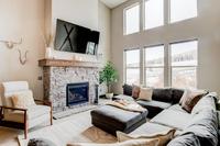 Unwind together in the living room after a long day in the mountains. Our spacious couch can accommodate any sized group, and the fireplace and smart TV are perfect to get cozy. 