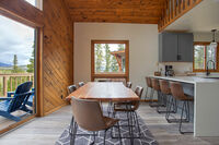 Alongside the dining table are four barstools along the kitchen countertop.  
| Lupine Lookout by Boutiq Luxury Vacation Rentals | Breckenridge, Colorado